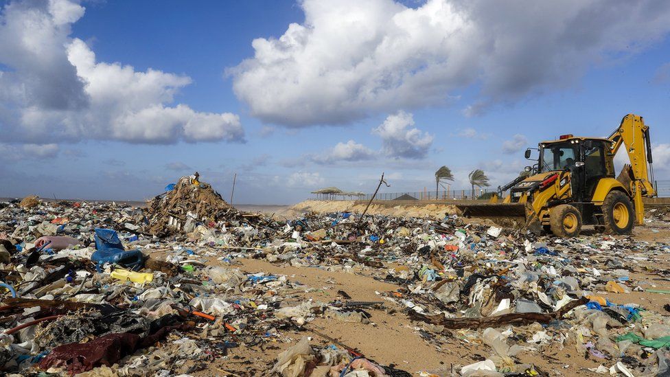 Diggers clean the beach of the coastal town of Zouk Mosbeh, north of Beirut, on January 23, 2018