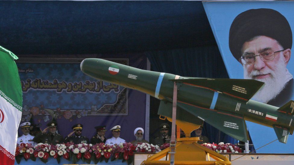 An Iranian military lorry carries missiles past a portrait of Iran's Supreme Leader Ayatollah Ali Khamenei during a parade on 18 April 2018 in Tehran