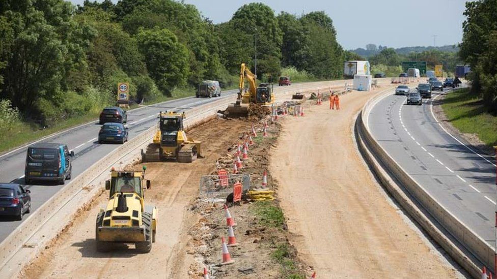 Workers dig on the A12
