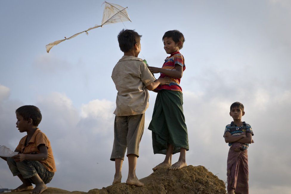 Children playing with a kite in one of the camps
