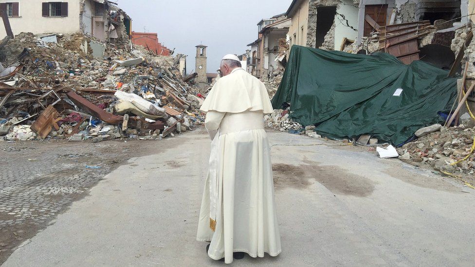 Pope Francis prays in Amatrice, Italy, during a surprise visit to the town that was devastated by an earthquake, 4 October 2016