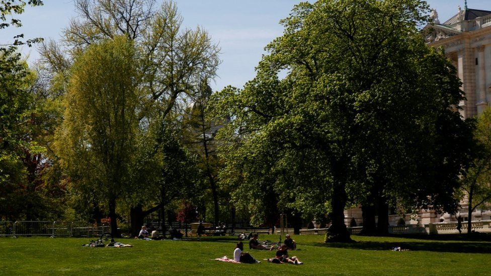 People sit in a park in Vienna