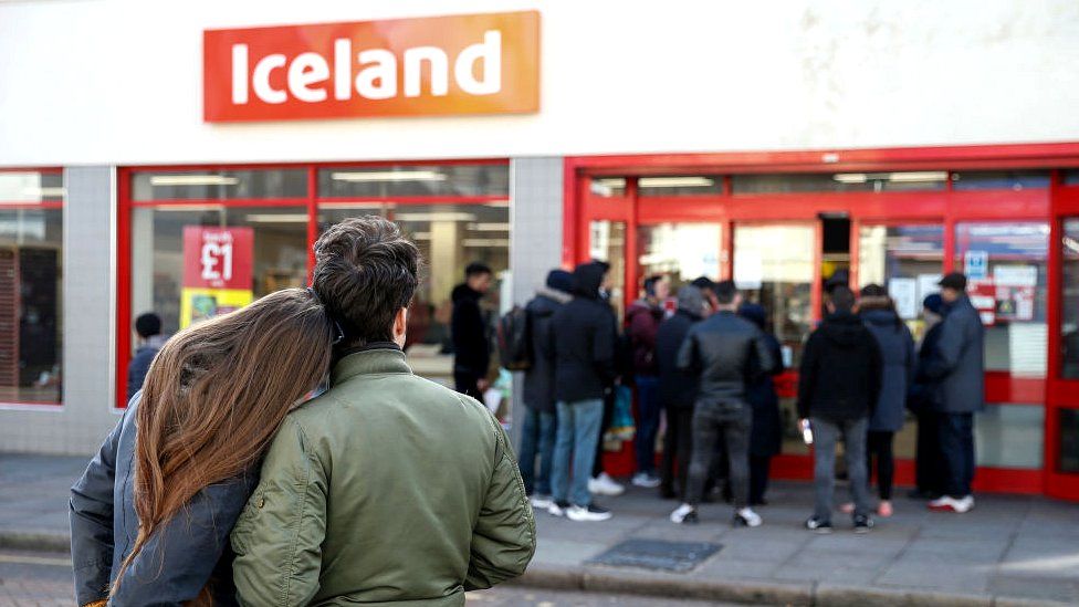 People stand outside Iceland store