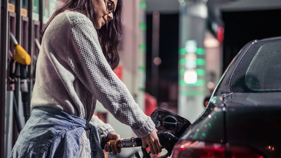 Woman filling car with petrol
