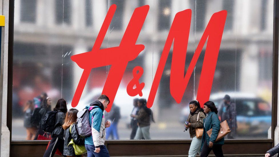 Shoppers walking past H&M store