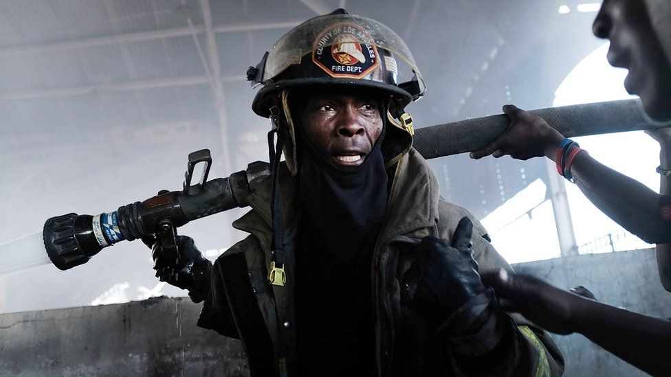A firefighter tackles the blaze in Port au Prince's Iron Market