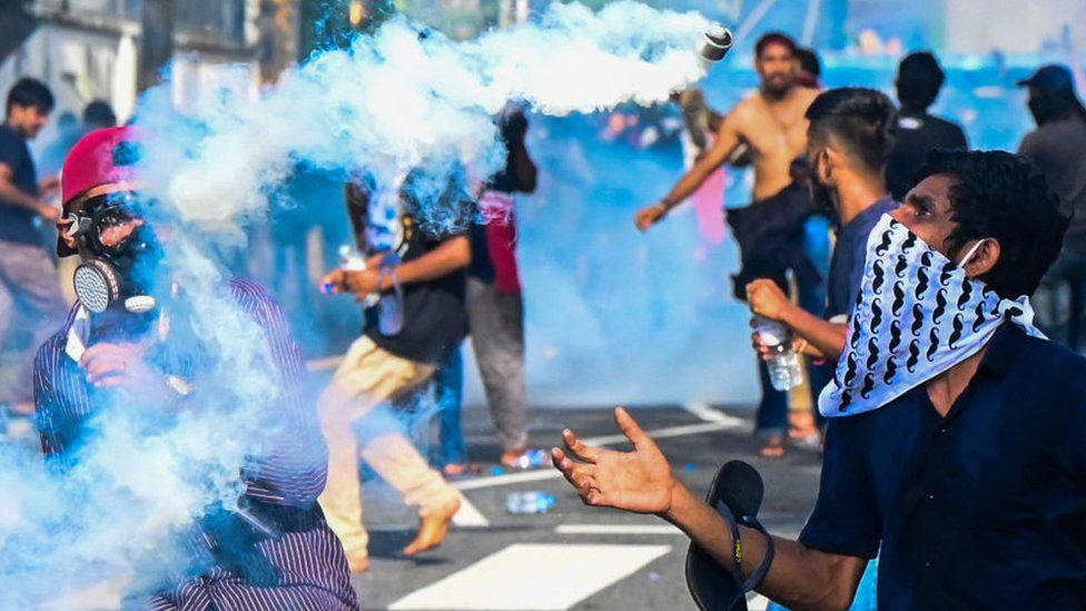 Police fire a tear gas canister at protestors in Sri Lanka