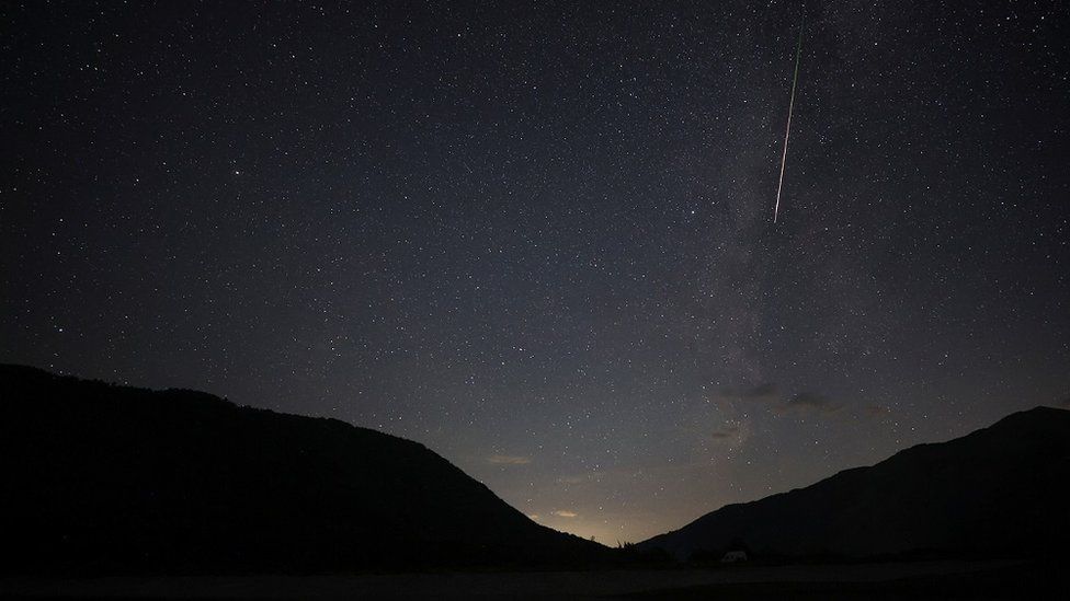 A meteor streaks in the night sky during annual Perseid meteor shower at Shebenik National Park, in Fushe Stude, Albania.