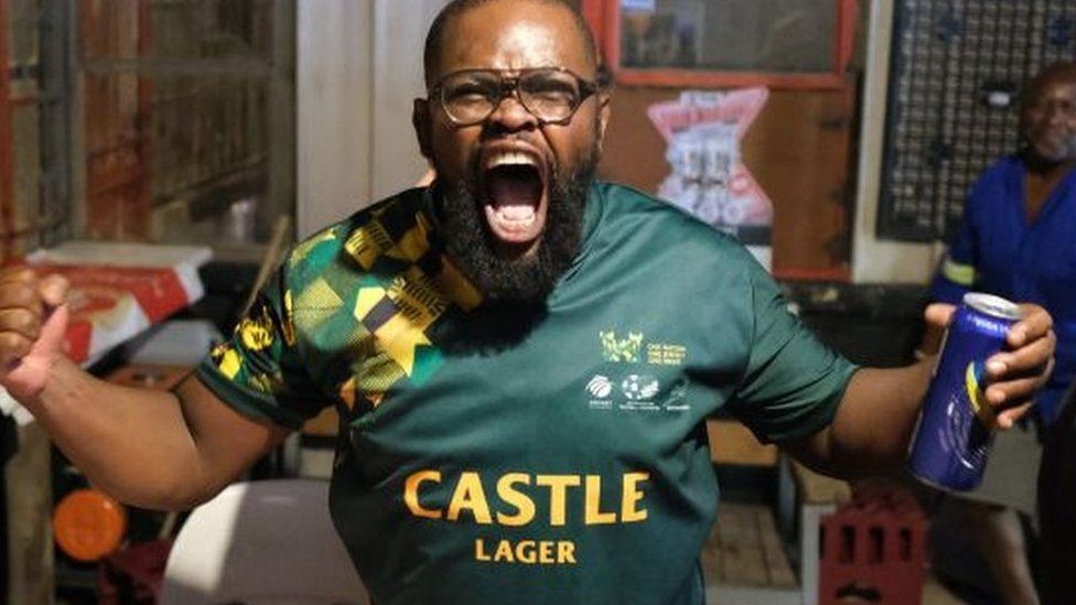 South African rugby supporters celebrate in Alexandra, near Johannesburg on October 28, 2023, after South Africa won the France 2023 Rugby World Cup final match between South Africa and New Zealand