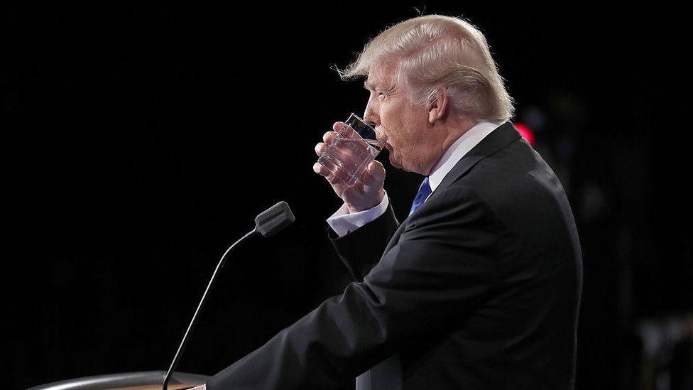 Donald Trump takes a drink of water during the Presidential Debate at Hofstra University