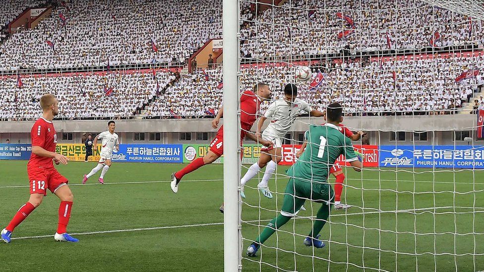 North Korea's Han Kwang-song fights for the ball with Lebanon's Nour Mansour at the Kim Il Sung Stadium, Pyongyang, in September 2019