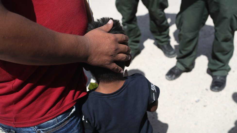 A small boy from Honduras and his father are taken into custody by US Border Patrol agents near the US-Mexico Border on June 12, 2018 near Mission, Texas.