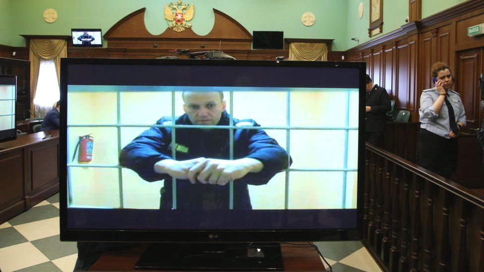 Russian opposition politician Alexei Navalny is seen on screen during his legal appeal against his nine-year prison sentence, in Moscow, 24 May 2022