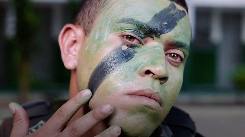 Soldier applying face paint