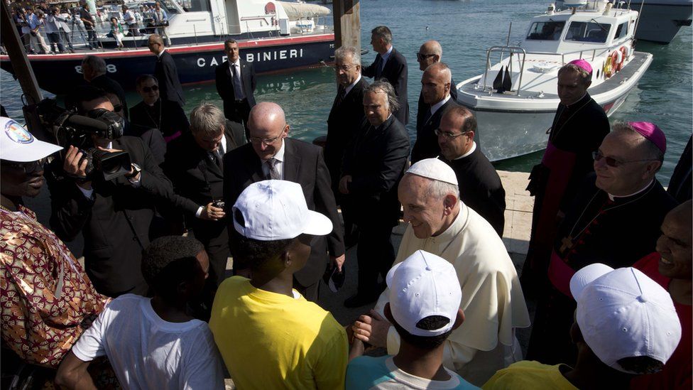 Pope Francis greets migrants during his visit to the island of Lampedusa in 2013