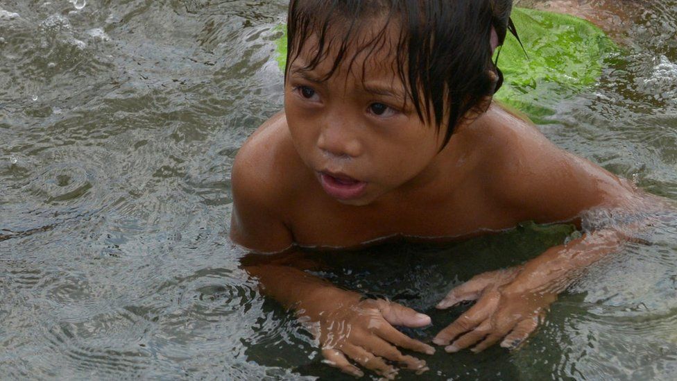 Child in dirty water