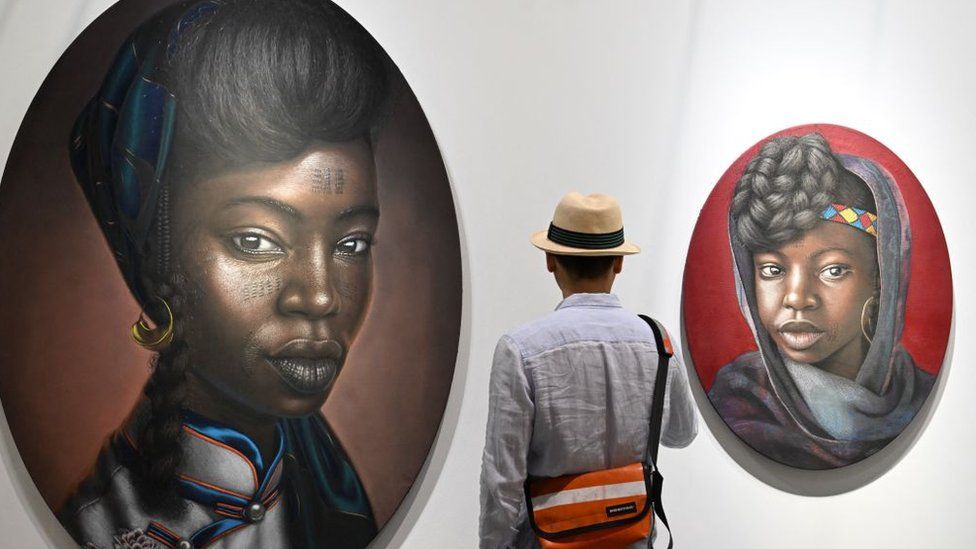 A visitor looks at works by Nigerian artist Babajide Olatunji at Art Basel in Hong Kong on March 27, 2024.