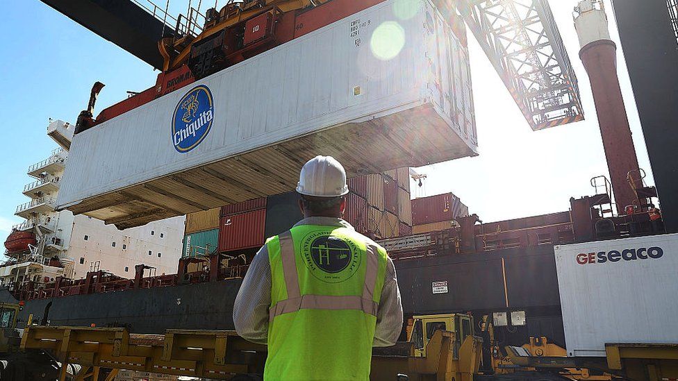 Shipping containers are offloaded from a cargo ship at Port Everglades in Fort Lauderdale, Florida.