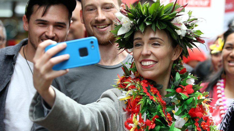 New Zealand"s Prime Minister Jacinda Ardern takes pictures with supporters during a campaign outing at Mangere Town Centre and market in Auckland, New Zealand, October 10, 2020.