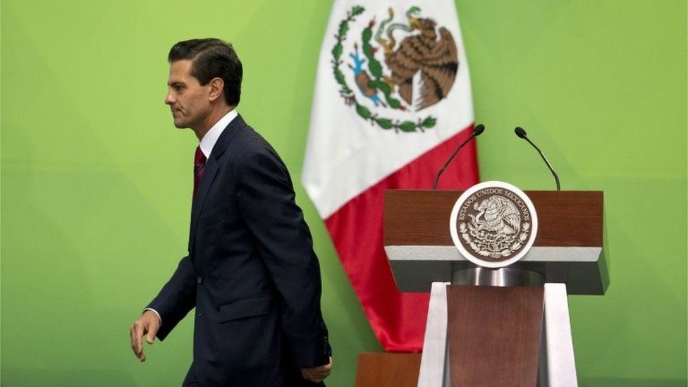 Mexican President Enrique Pena Nieto leaves the podium after speaking during an event to present a national policy on financial inclusion in Mexico, at the National Palace in Mexico City, Tuesday, June 21, 2016.