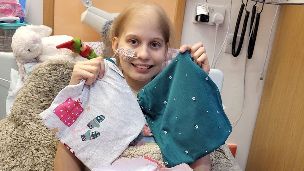 Teenager in hospital bed with gifts
