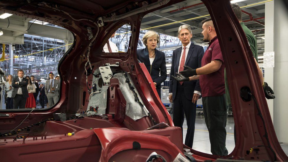 Theresa May and Philip Hammond visit a car plant