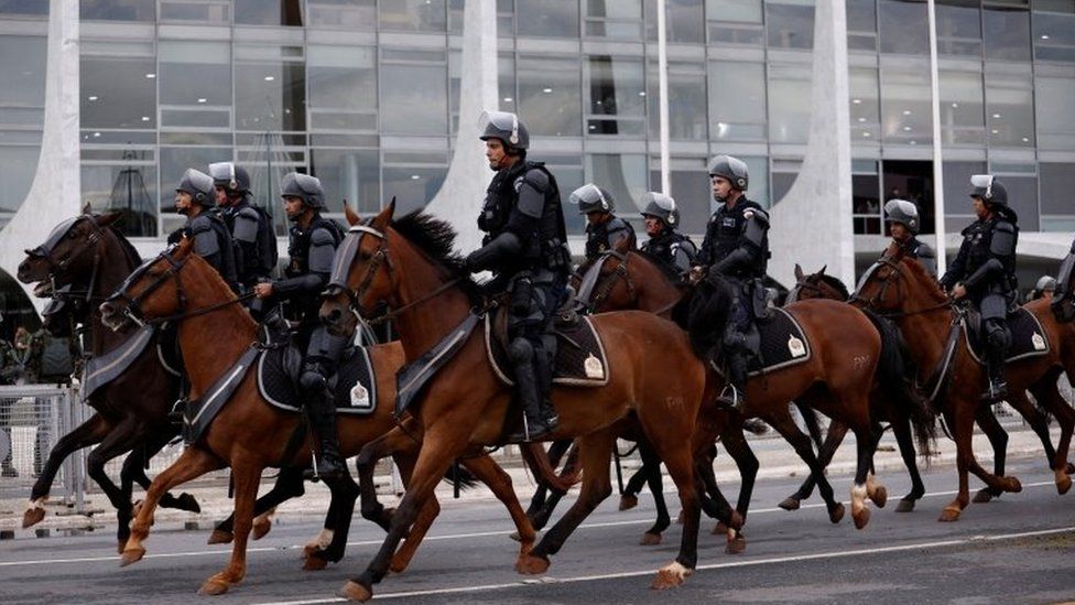 Security forces mounted on horses stand guard outside the presidential palace in Brasília. Photo: 11 January 2023