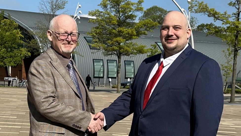 David Sims and Matt Keane shaking hands