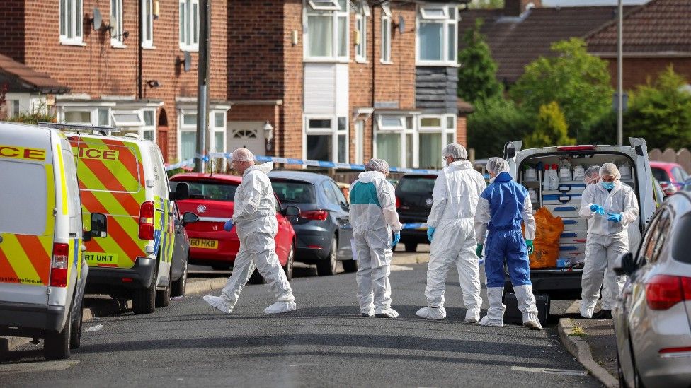 Forensic officers near to the scene in Kingsheath Avenue, Liverpool,