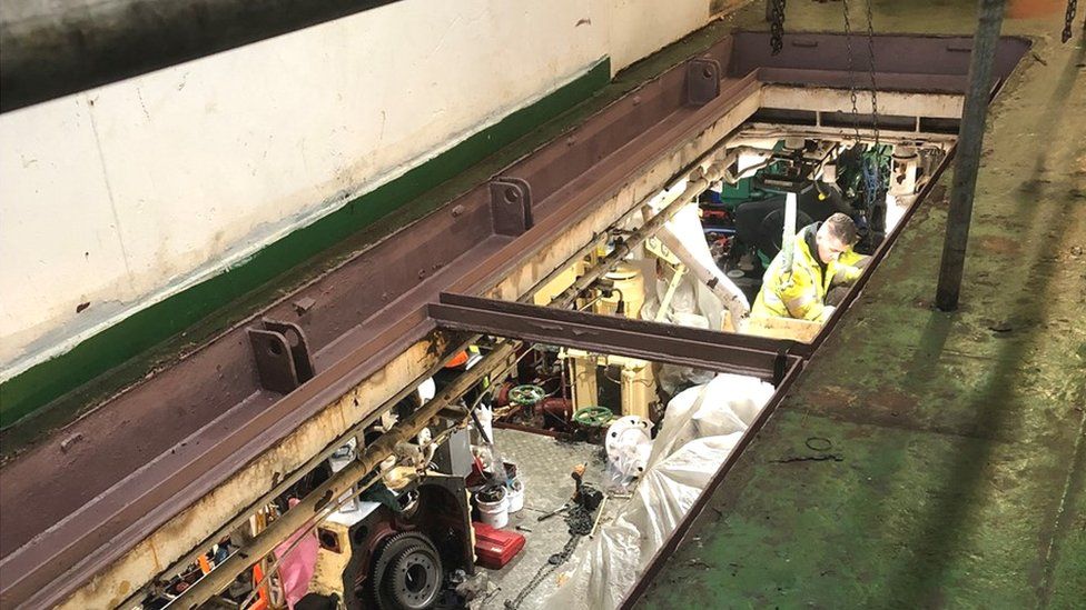 Below the cardeck, work goes on in the engine room
