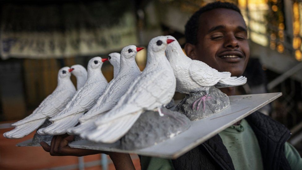 A man carrying paper doves to be sold in Ethiopia - Monday 13 November 2023.