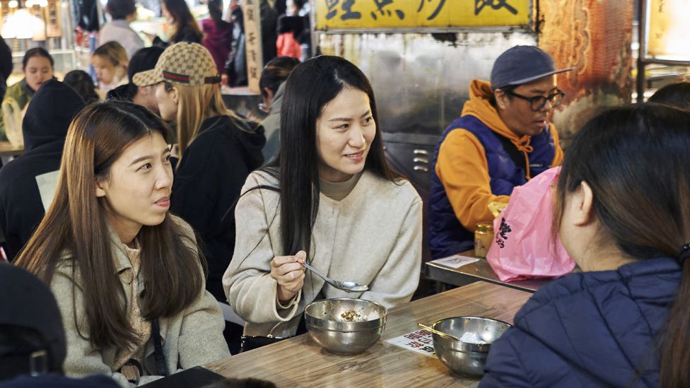 Diners eat at a food stall at the Ningxia Night Market in Taipei