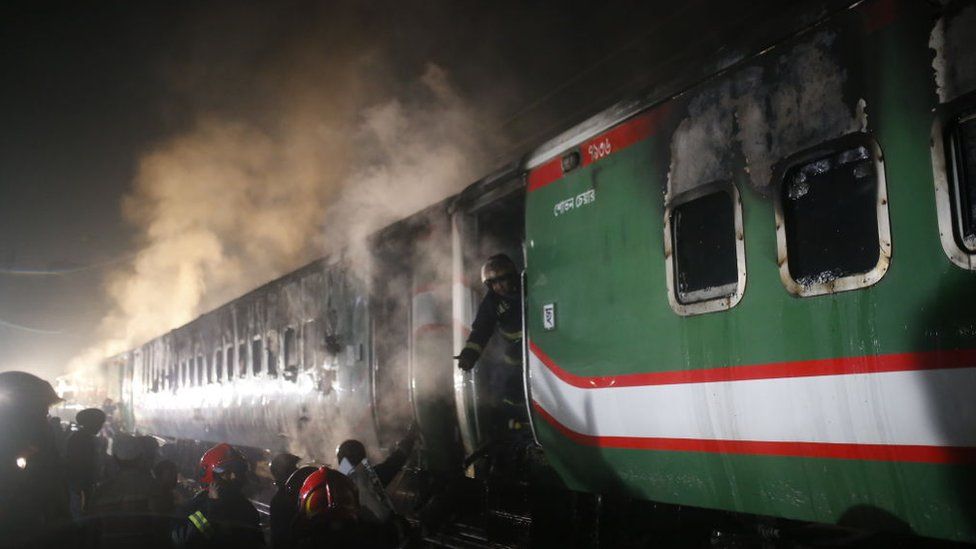 Firefighters are trying to extinguish a fire after arsonists set a Benapole Express train ablaze in Dhaka, Bangladesh