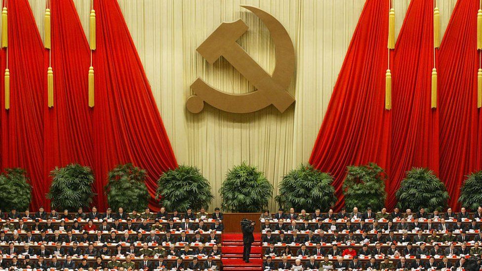 - Delegates and China's top leaders beneath a Communist hammer and sickle emblem, 08 November 2002