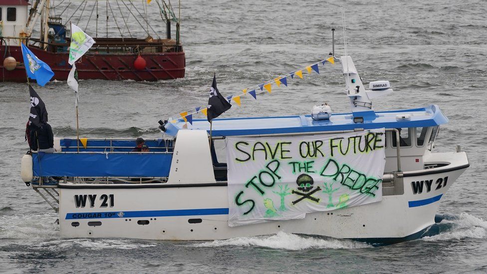 Boat flies save our sea banner