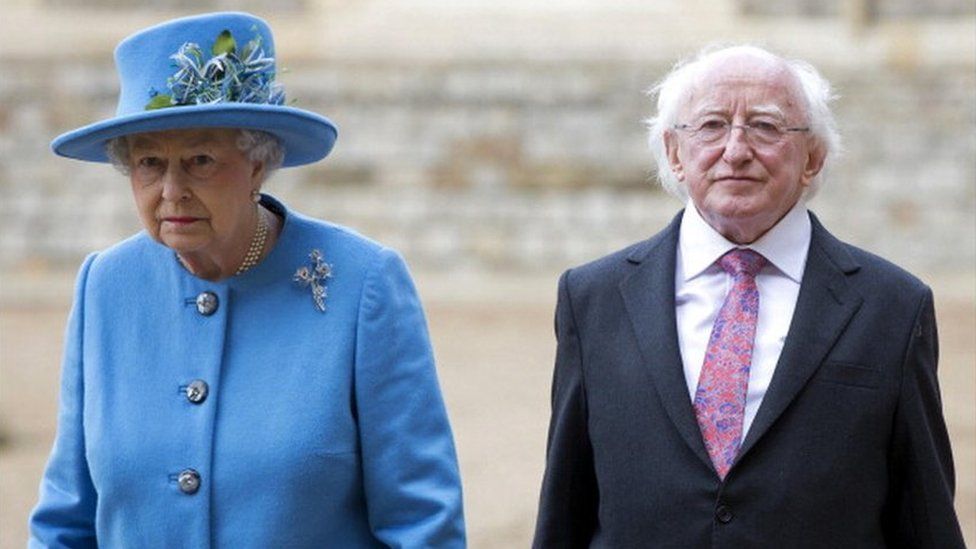 Britain's Queen Elizabeth II and Irish President Michael D. Higgins (R) walk together during a ceremonial welcome at Windsor Castle in Windsor, west of London on April 8, 2014
