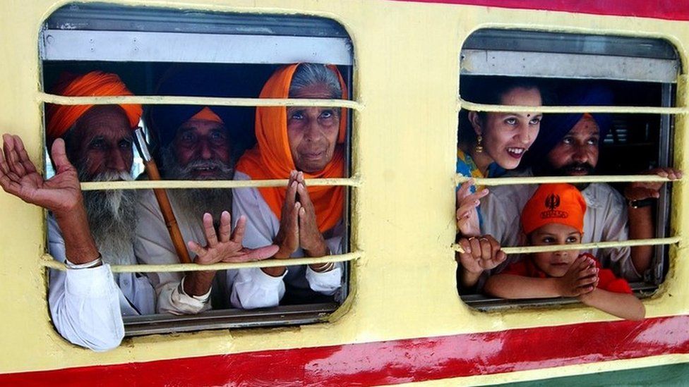 Sikh pilgrims board a train at Amritsar railway station
