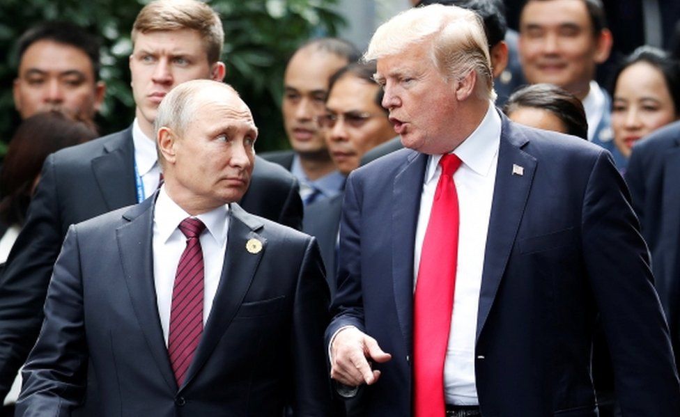 Russia's President Vladimir Putin walks alongside US President Donald Trump in November 2017