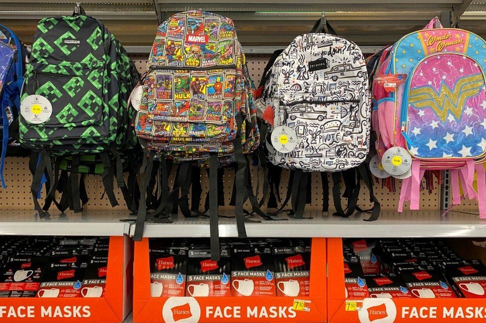Face masks are shown for sale with back packs and back to school supplies at a Walmart store during the outbreak of the coronavirus disease in California