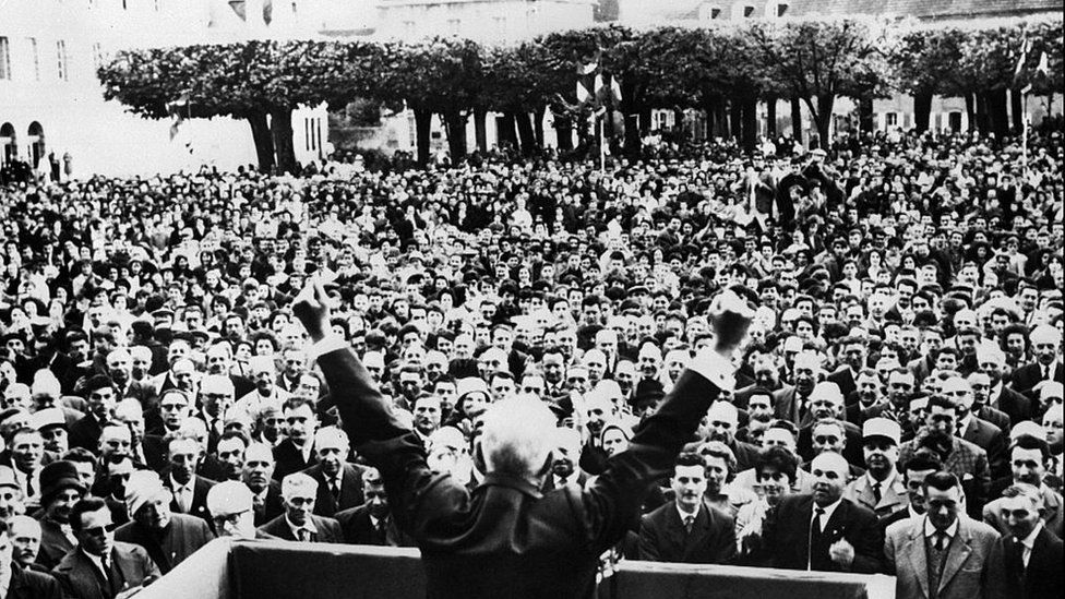 Charles de Gaulle raises his arms in victory as he addresses the crowd 19 May 1962 in the small town of Gueret in central France