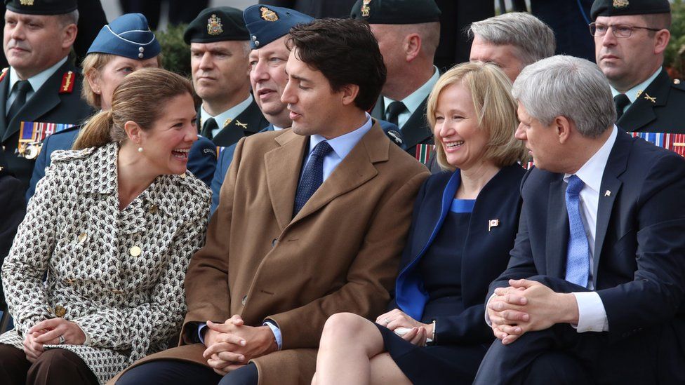Sophie Gregoire-Trudeau, Justin Trudeau, Laureen Harper and Prime Minister Stephen Harper sit and talk before a ceremony