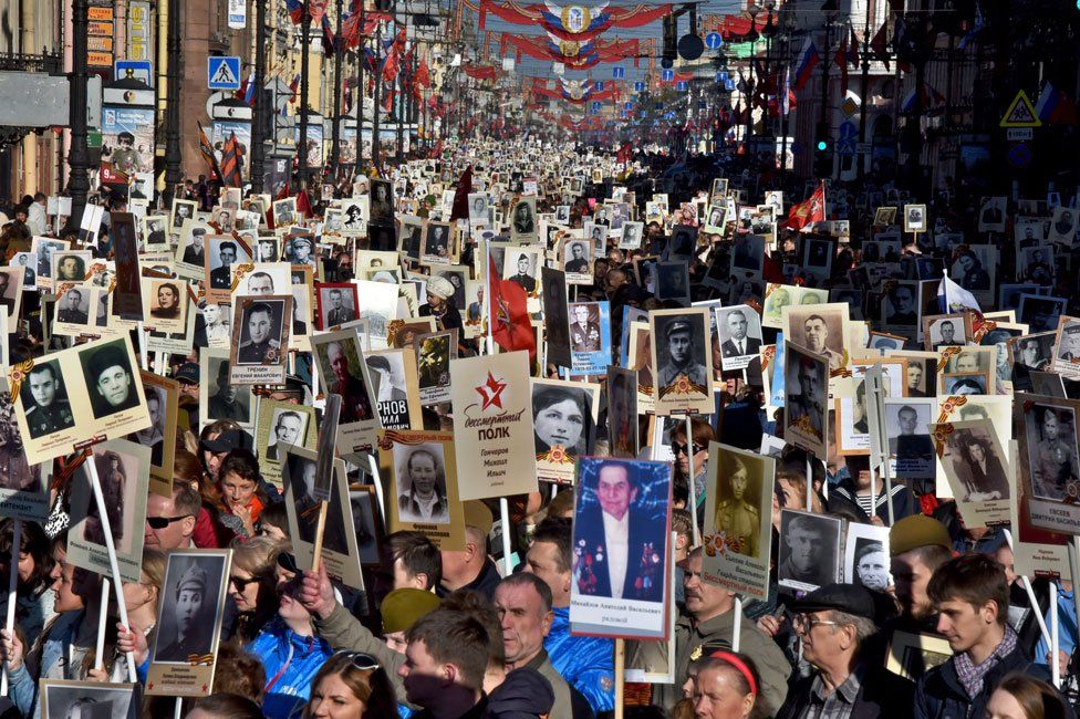 People carry portraits of WW2 soldiers in the Immortal Regiment march in St Petersburg
