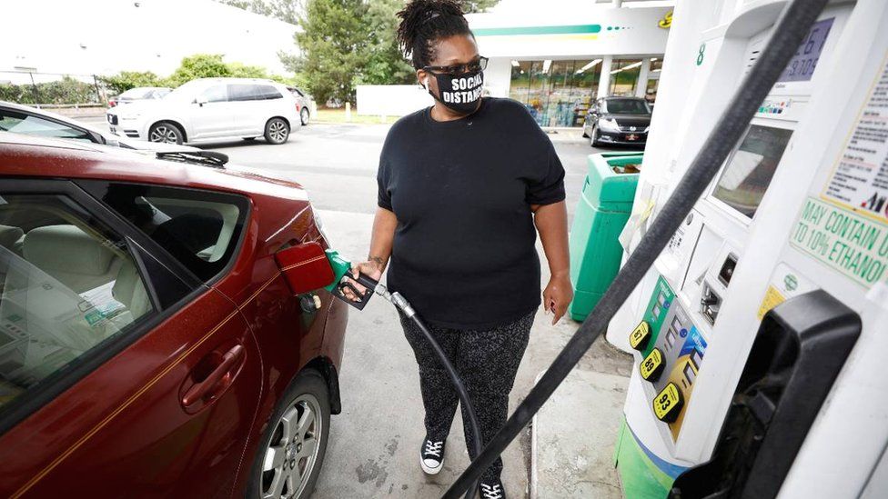 A woman filling her car in Durham, North Carolina