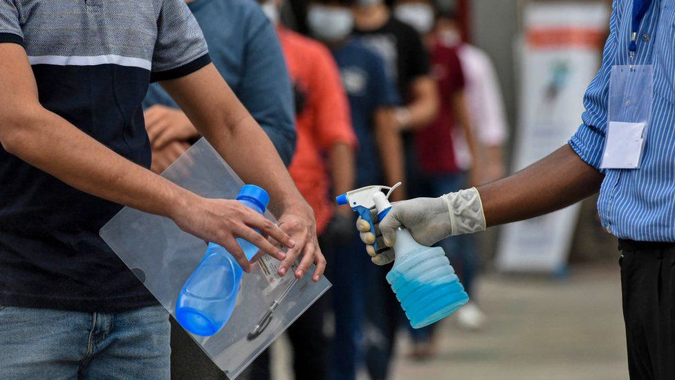 JEE aspirants sanitise their hands while exiting the examination