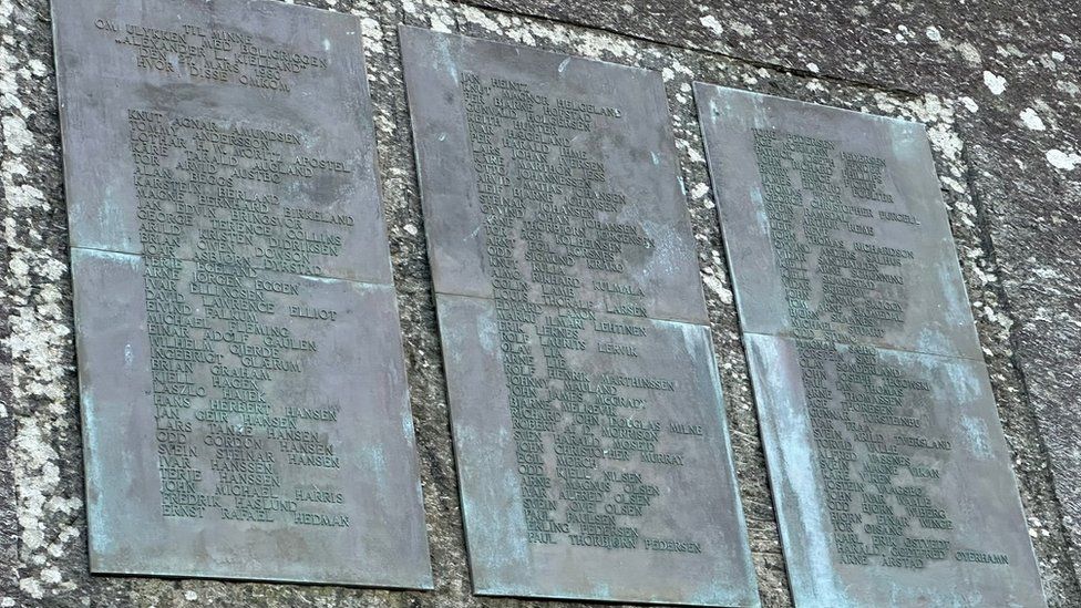 Three large metal plates with names written on