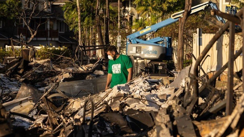 A Mercy Worldwide volunteer makes damage assessment of charred apartment complex in the aftermath of a wildfire in Lahaina, western Maui, Hawaii on August 12, 2023.