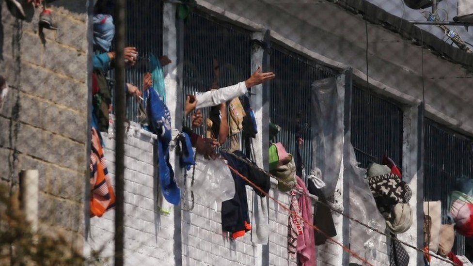 Prisoners are seen at windows inside La Modelo prison in Bogotá