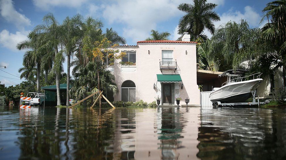 A home is seen surrounded by flood water caused by the combination of the lunar orbit which caused seasonal high tides and what many believe is the rising sea levels due to climate change on September 30, 2015 in Fort Lauderdale, Florida