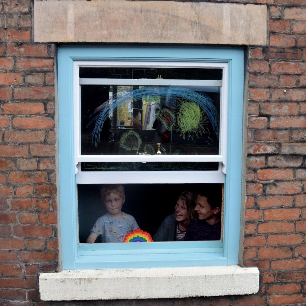 Family at a rainbow window