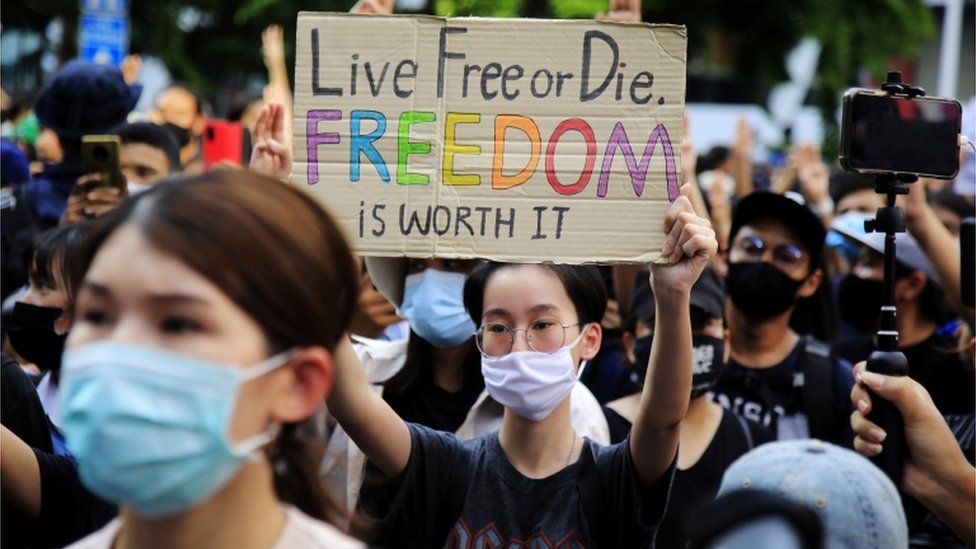 A pro-democracy protester holds up a placard during a rally against the state of emergency at Ratchaprasong district in Bangkok, Thailand, 15 October 2020